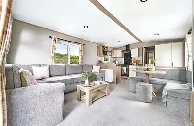 a living room with a couch and a table at Queensberry Bay Essential Clover Caravan Pet in Annan