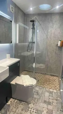 a bathroom with a shower and a toilet and a sink at The Anne'x in Dalbeattie