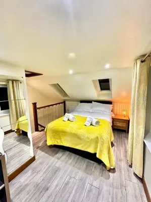 a bedroom with a bed with two towels on it at The Anne'x in Dalbeattie