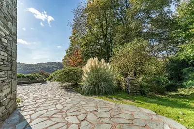 a stone walkway in a garden with trees at Langdale Crag in Grasmere