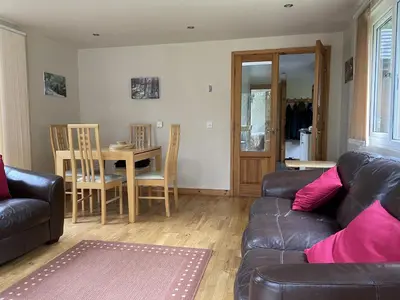a living room with a couch and a table at The Shack, Cally Avenue, Gatehouse of Fleet, Dumfries and Galloway, DG7 2 DH in Gatehouse of Fleet