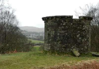 an old stone wall sitting on top of a field at Luxurious Georgian Town House in Langholm