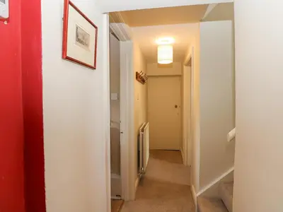 a hallway with a door leading into a room at John Duftons Barn in Cockermouth