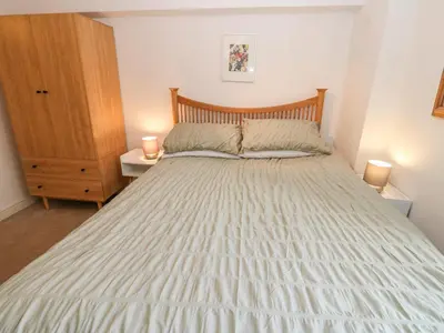 a bedroom with a large bed with two night stands at John Duftons Barn in Cockermouth