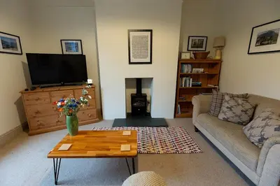 a living room with a couch and a coffee table at RIDGEMOUNT APT - Great base for walking and cycling in Keswick, Lake District National Park in Keswick
