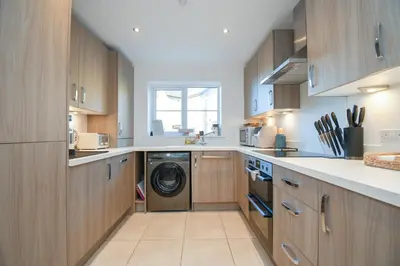 a kitchen with a washer and dryer in it at Lake District Haven - Modern Comfort in Cockermouth in Cockermouth