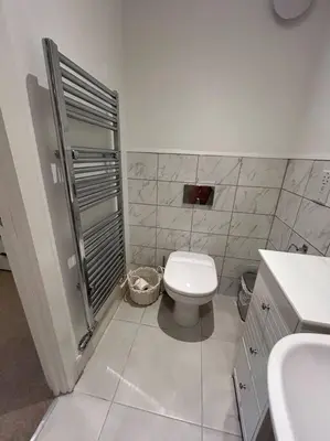 a white bathroom with a toilet and a sink at Lake District Haven - Modern Comfort in Cockermouth in Cockermouth