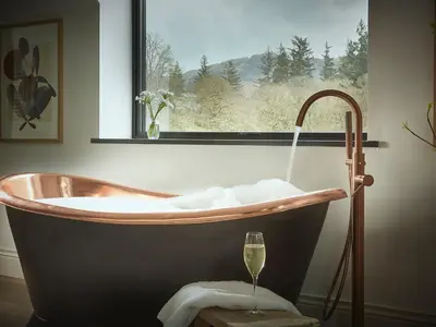 a bath tub in a bathroom with a window at Eskdale Retreat in Holmrook