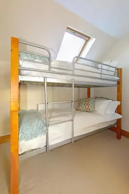 two bunk beds in a room with a window at Inchlonaig House in Port William
