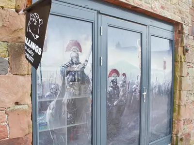 a window with a painting of a group of soldiers at Tiberius Claudius Augustus Suite - Uk43559 in Bowness-on-Solway