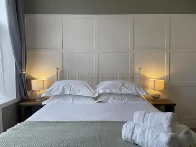 a bedroom with a bed with two towels on it at The Tops in Keswick