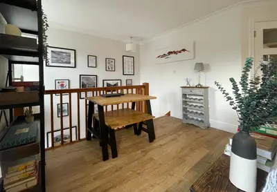 a living room with a wooden table and a desk at The Tops in Keswick
