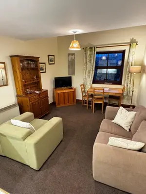 a living room with a couch and a table at The Wasdale Head Inn & Apartments in Seascale