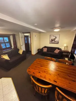 a living room with a wooden table and a couch at The Wasdale Head Inn & Apartments in Seascale