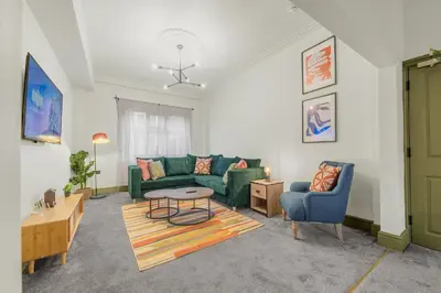 a living room with a couch and a table at Boutique Home in Lake District, West Cumbria in Workington