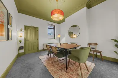 a dining room with a table and chairs and a mirror at Boutique Home in Lake District, West Cumbria in Workington