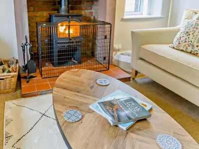 a living room with a coffee table and a fireplace at 4 Bed in Keswick oc-95739 in Bassenthwaite