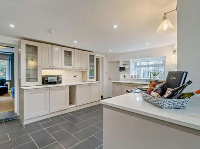 a kitchen with white cabinets and a counter top at 4 Bed in Keswick oc-95739 in Bassenthwaite