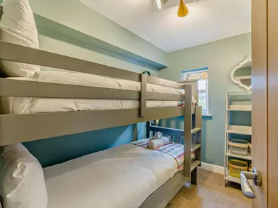 two bunk beds in a room with blue walls at 4 Bed in Keswick oc-95739 in Bassenthwaite