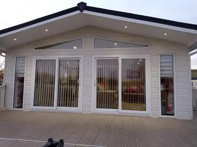 a screened in porch of a house with windows at Muirfield cosy retreat in Girvan