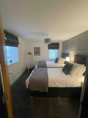a bedroom with two beds and a window at Watchhall, Annan, Dumfries & Galloway, Scotland Barn - 2 Bed in Annan