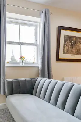 a couch in a living room with a window at John Dalton House in Cockermouth