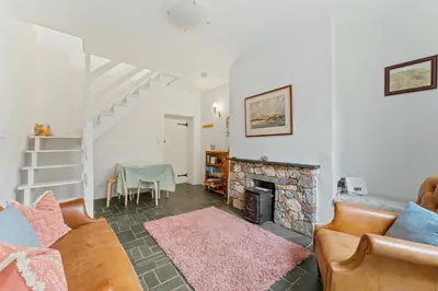 a living room with a couch and a fireplace at The Escape in Portinscale