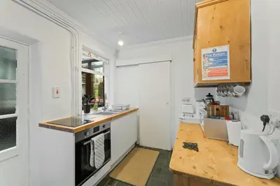 a kitchen with a sink and a stove top oven at The Escape in Portinscale