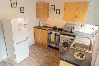 a kitchen with a refrigerator and a stove and a sink at CS House in Carlisle