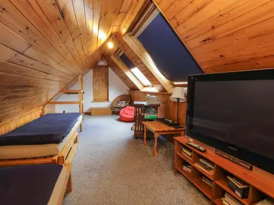 a living room with a large screen tv in a cabin at Brews Cottage in Keswick