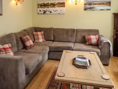 a living room with a couch and a coffee table at Brews Cottage in Keswick