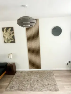 a living room with a rug and a chandelier at CosyHouse1 Private Parking Base for Lake District and Sellafield in Cleator