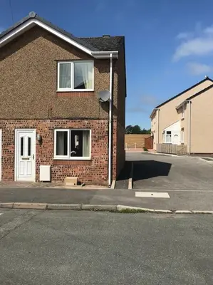 a brick house with a window on a street at CosyHouse1 Private Parking Base for Lake District and Sellafield in Cleator