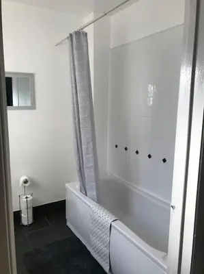 a white bathroom with a tub and a shower at Spacious Property For Hols Base & Contractors Long or Short Stays C2C Western Lakes in Cleator Moor