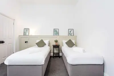 two beds are lined up in a room at The Fairlie Suite No2 in Prestwick