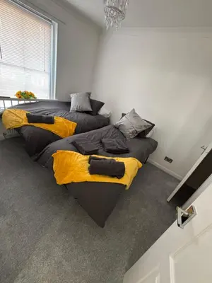 two beds in a room with yellow and black at No 10, Ayr, 130m2, New Decor December 2024, All new entire 3 bedroom garden house in Ayr