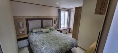 a bedroom with a large bed and a window at Ramblers Retreat in Cockermouth