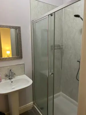a bathroom with a shower and a sink at 10 Thurnams House in Carlisle