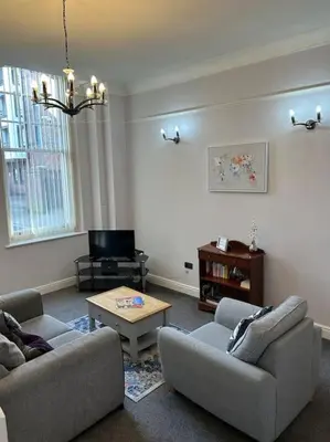 a living room with two couches and a coffee table at 10 Thurnams House in Carlisle