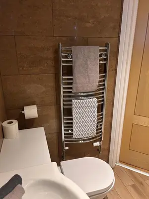 a bathroom with a toilet and a towel rack at New Road Apartment - 2 Bedrooms - Sleeps 3 in Whitehaven