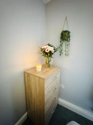 a vase of flowers on a dresser in a room at New Road Apartment - 2 Bedrooms - Sleeps 3 in Whitehaven