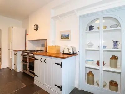 a kitchen with white cabinets and a counter top at Middletown in Keswick