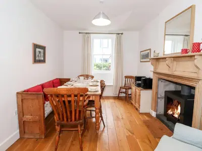 a dining room with a table and a fireplace at Middletown in Keswick