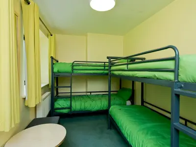 a room with two bunk beds and a table at YHA Ennerdale in Buttermere