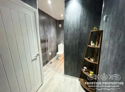 a bathroom with a book shelf next to a toilet at Jackson St by Prestige Properties SA in Siddick
