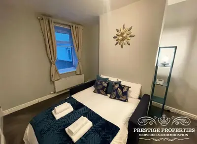 a bedroom with a bed with blue and white sheets at Jackson St by Prestige Properties SA in Siddick