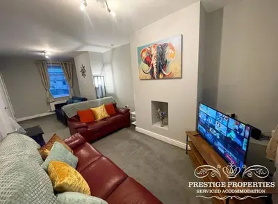 a living room with a couch and a flat screen tv at Jackson St by Prestige Properties SA in Siddick
