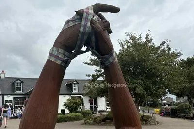 a statue of a horse statue in front of a house at The Cosy Hedgerow in Port Carlisle