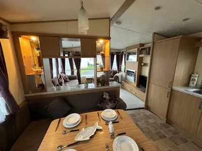 a dining room with a table in a rv at The Cosy Hedgerow in Port Carlisle