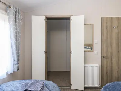 a bedroom with an open door to a closet at Brocklebank Lodge, 35 in Carlisle